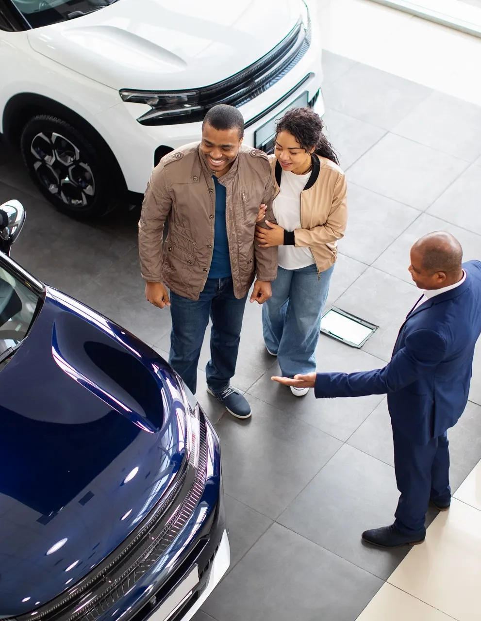 couple-with-dealer-in-showroom-1920w Couple with dealer in showroom